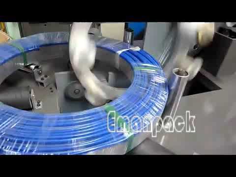 Horizontal coil wrapping machine packaging large rolls of hose and pipe