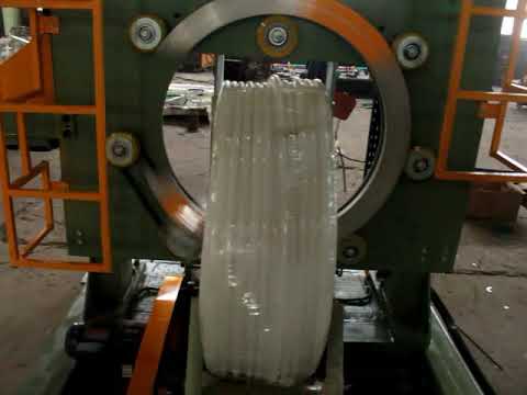 Plastic pipe coil packing machine with stretch film wrapping