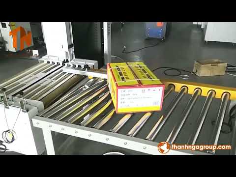 Dán thùng kết hợp đóng đai thùng tự động - Sealing cartons combined with automatic carton strapping