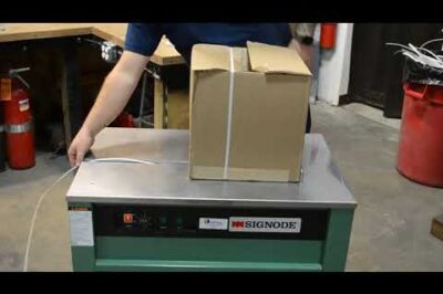 Strapping machine for packaging and shipping needs.