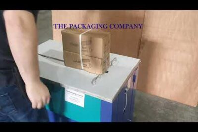 Strapping machine that requires manual assistance.