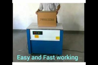 Box strapping machine with semi-automatic operation.