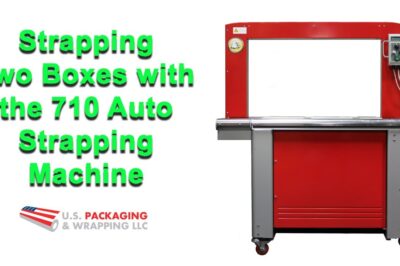 Automated machine secures two boxes together with strapping.