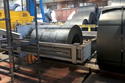 Double Head Strapping Machine for hot coils with circumferential capability.