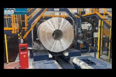 Machine for strapping aluminum coils around their circumference