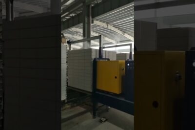 Vertical strapping machine for PET pallets used in brick production.