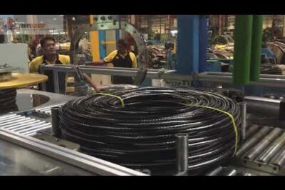 Cable coiling and strapping machine with pay off.