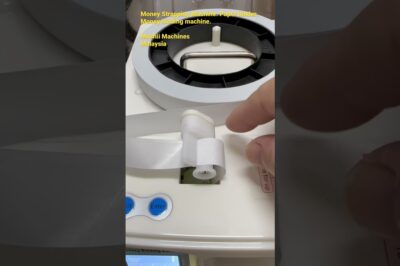 Feeding paper roll into a money strapping machine: a simplified guide for paper binding in less than 28 words.
