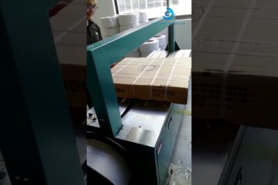 Large PP strapping machine for sealing and packing big carton boxes with wide dimensions.