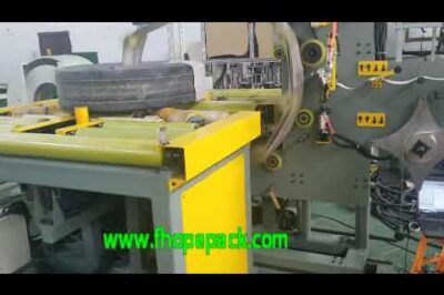 Automatic paper packaging machine for large steel coils.