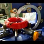 coil packing and stretch wrapping machine for hoses and pipes.