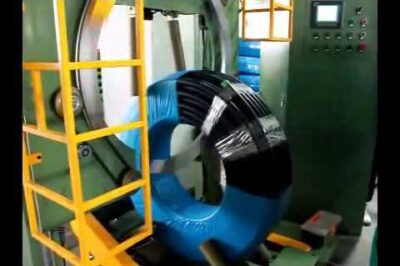 Coil wrapping machine for pipes, hoses, and PVC packaging.