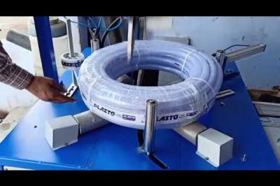 Coil wrapping machine for wire coiling and packaging of braided hoses.