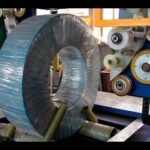 "compact machine wraps coils with stretch film and woven material"