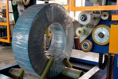 “Compact Machine Wraps Coils with Stretch Film and Woven Material”