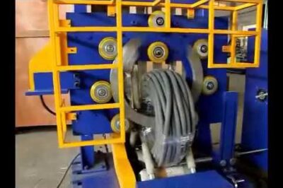 Compact coil packing machine for corrugated hose and pipes.