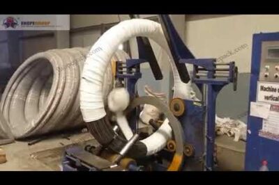 Compact machine for packing prestressed steel wire coils.