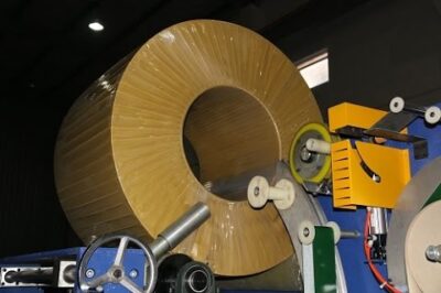 Compact machinery for packing and wrapping coils.
