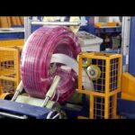 compact packing machine for hoses and pipes with coil wrapping