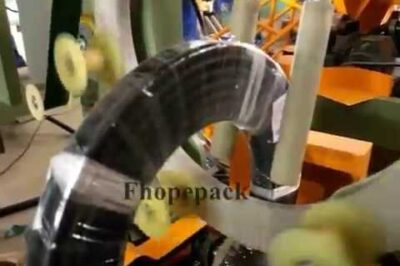 Compact packing machine for hoses and pipes, with efficient coil wrapping.
