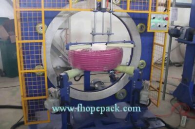 Compact stretch wrap machine for pipe coils.