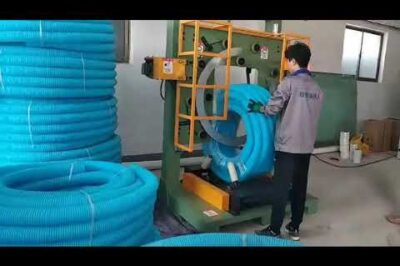 Compact vertical hose coiling machine.