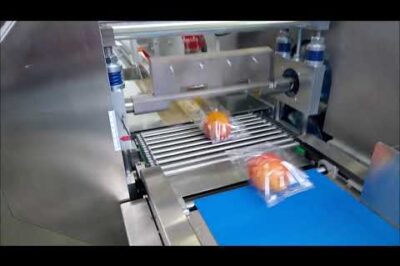 Food packaging machine with horizontal flow pack design.
