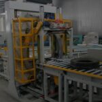 horizontal tire packing line with automatic stretch wrapper.