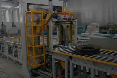 Horizontal tire packing line with automatic stretch wrapper.