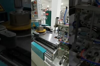 Wire and cable coiling, labeling, and film packing machine with automation.