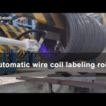 Wire coil labeling robot for robotic coil packaging system.