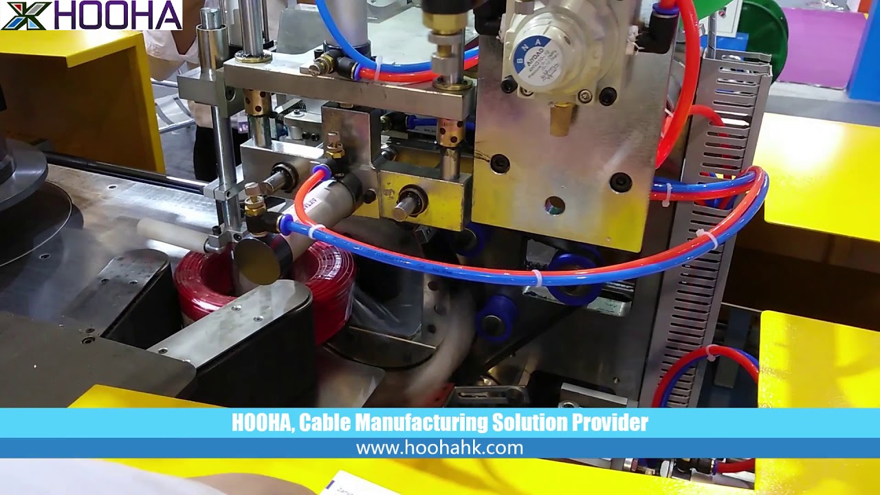 Wire coiling and packaging machine with automatic wrapping capabilities